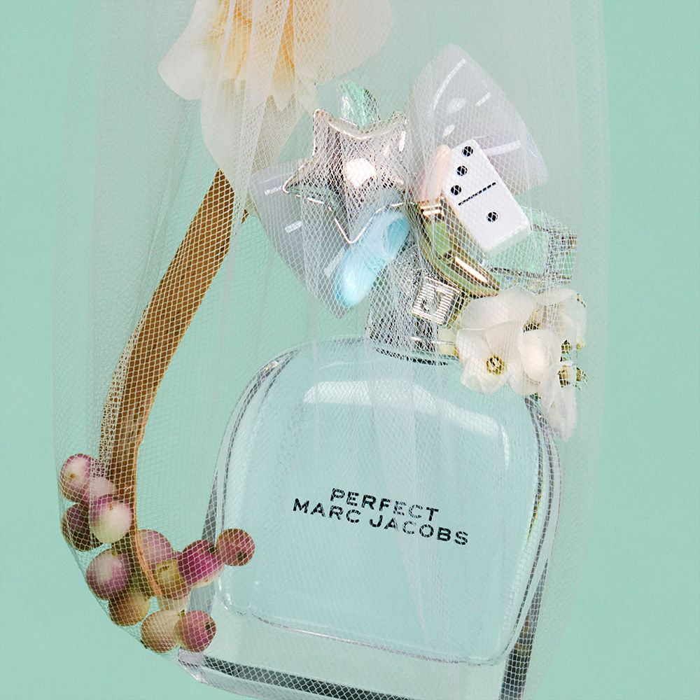 Faceted clear 50 ml eau de toilette bottle with silver cap and small bow