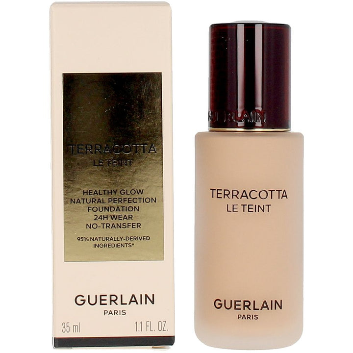 Frosted glass foundation bottle with dark brown embossed cap and gold-label rectangular box, Guerlain