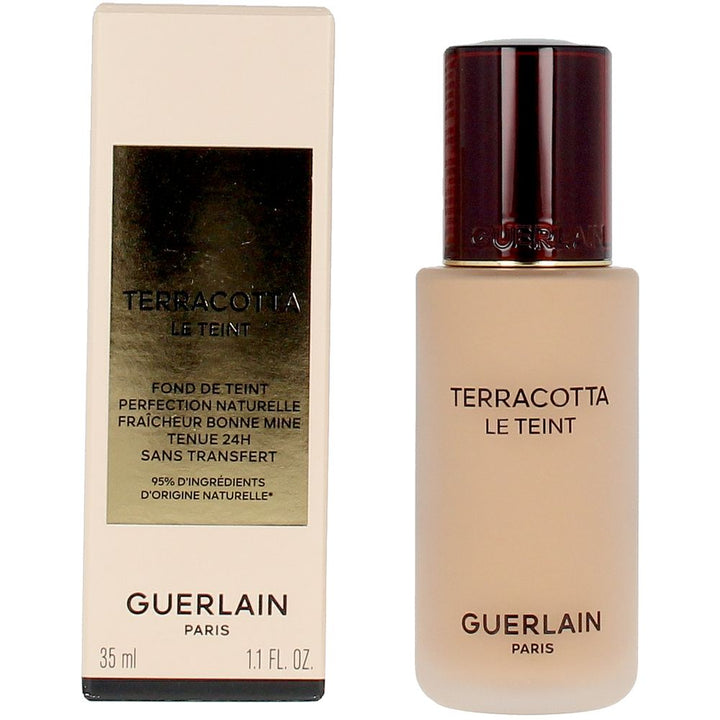 Frosted glass foundation bottle with dark brown embossed cap and gold-label rectangular box, Guerlain