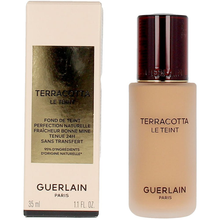Frosted glass foundation bottle with dark brown embossed cap and gold-label rectangular box, Guerlain