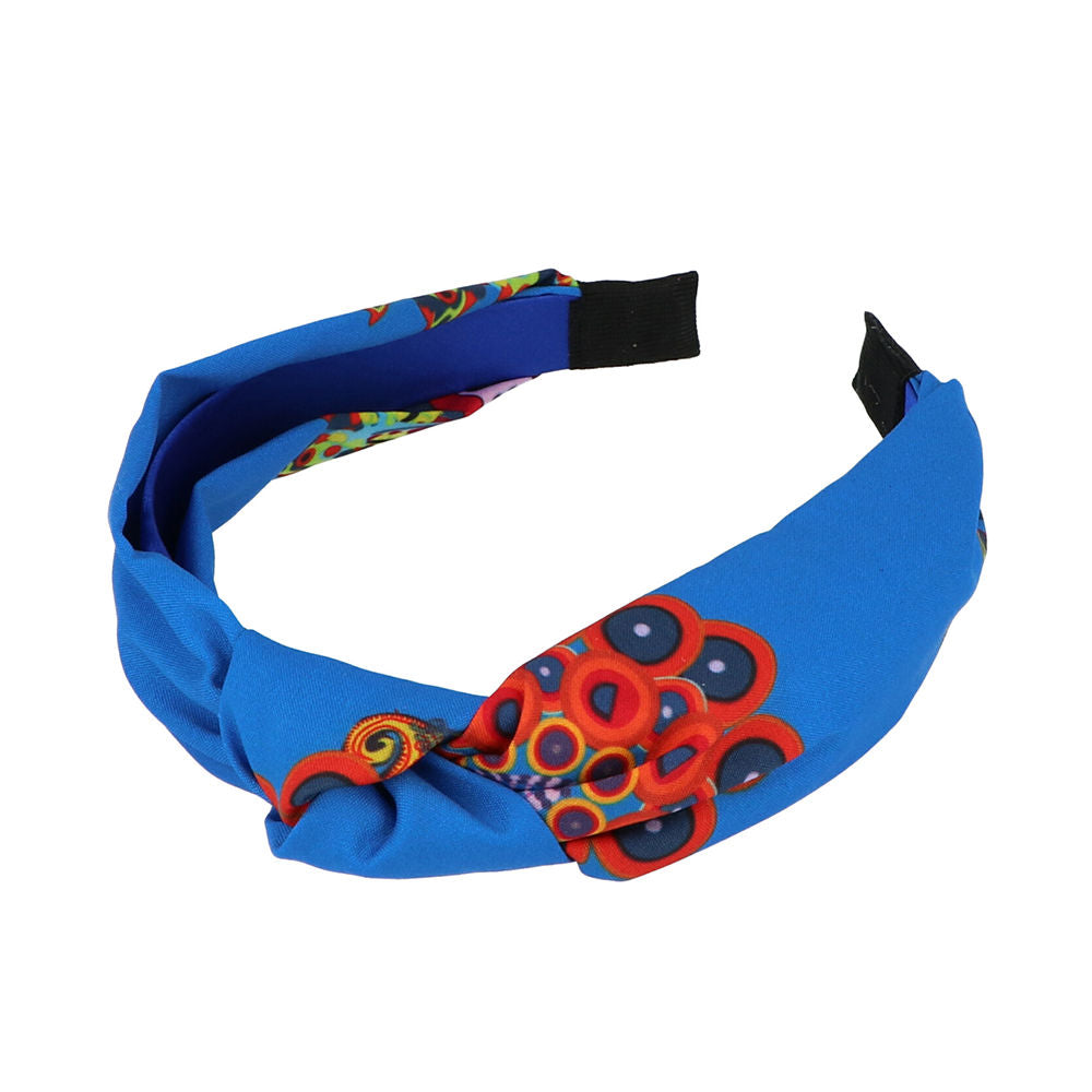 Inca Blue, red, and black patterned fabric headband with knotted top and circular print