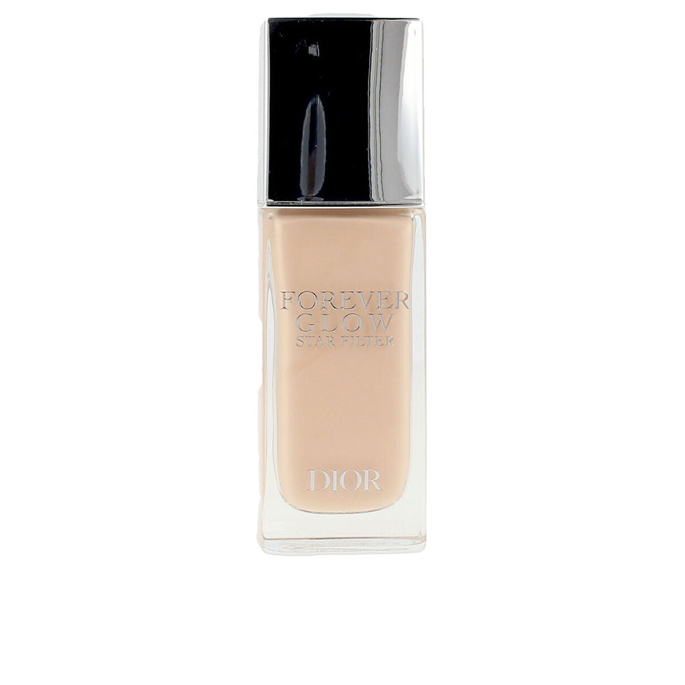 Small pump bottle of lightweight luminous fluid, pale champagne shade, liquid texture