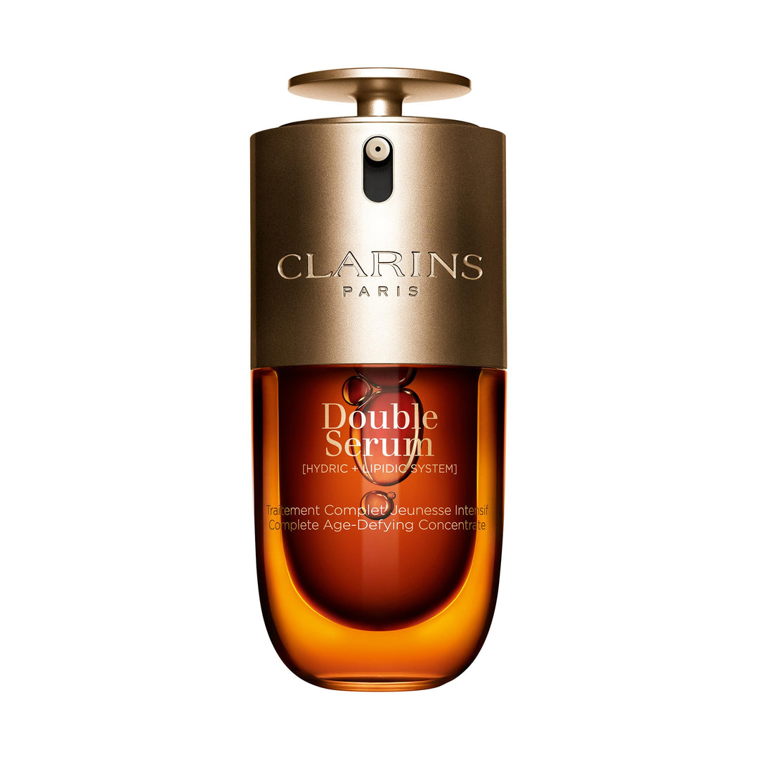 Clarins Glass dual-phase serum bottle with clear and golden liquids, dropper dispenser and minimalist label