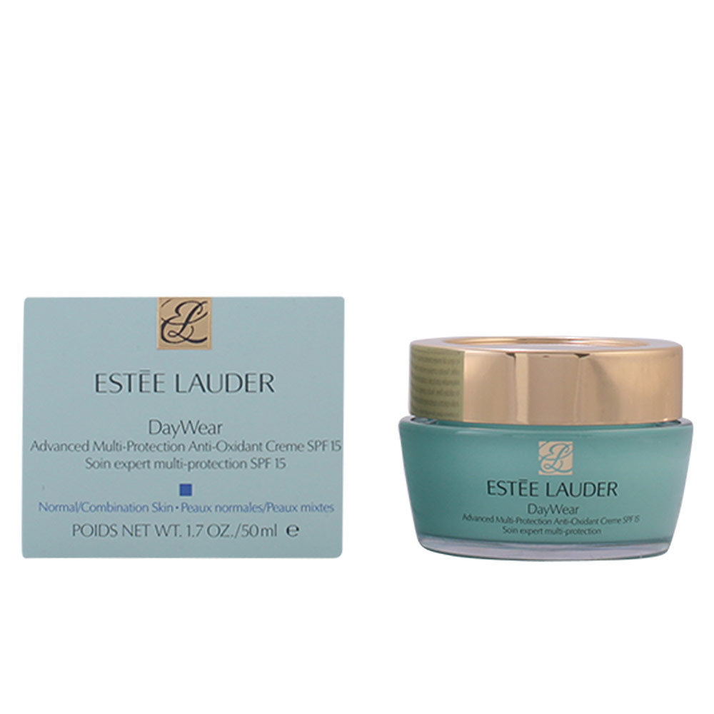 Estée Lauder Teal face cream jar with gold lid and printed logo beside matching box, plastic jar and lid