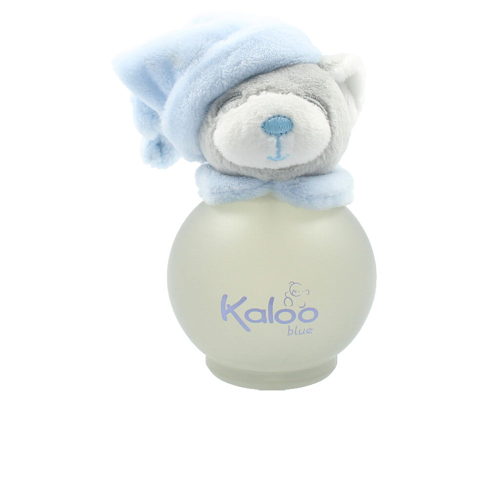Kaloo Round frosted glass bottle with plush bear-head stopper wearing hat, light blue and grey tones.