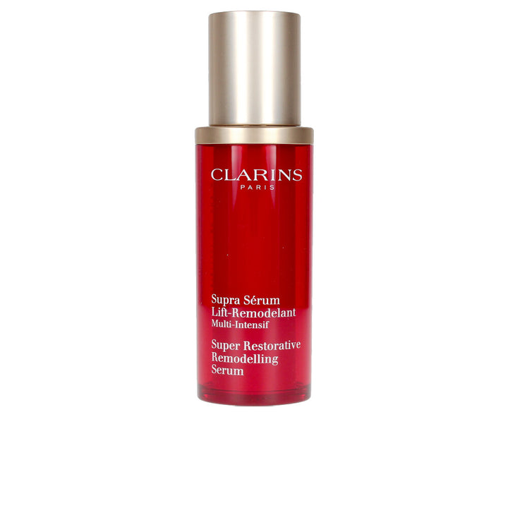 Clarins red and gold opaque plastic serum bottle with pump dispenser, modern sleek silhouette, refined finish.
