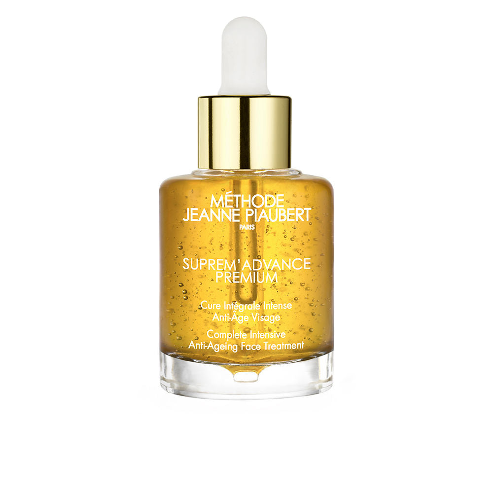 Jeanne Piaubert Transparent glass face serum bottle with golden-yellow liquid, gold metal cap, white dropper, printed white text
