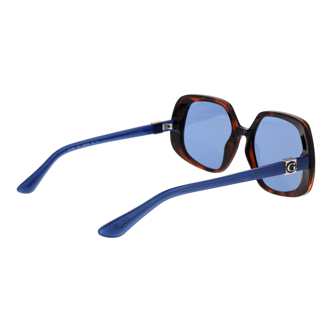 Tortoise shell oversized square sunglasses with blue-tinted lenses and logo temple detail on white background
