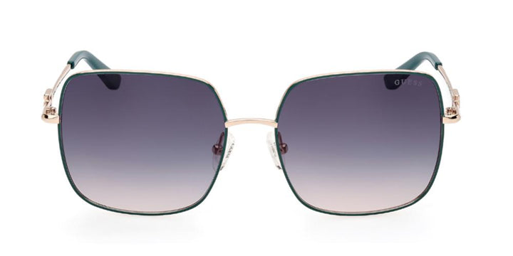 Gold metal square sunglasses with green to purple gradient lenses and decorative temple logo, nose pads visible