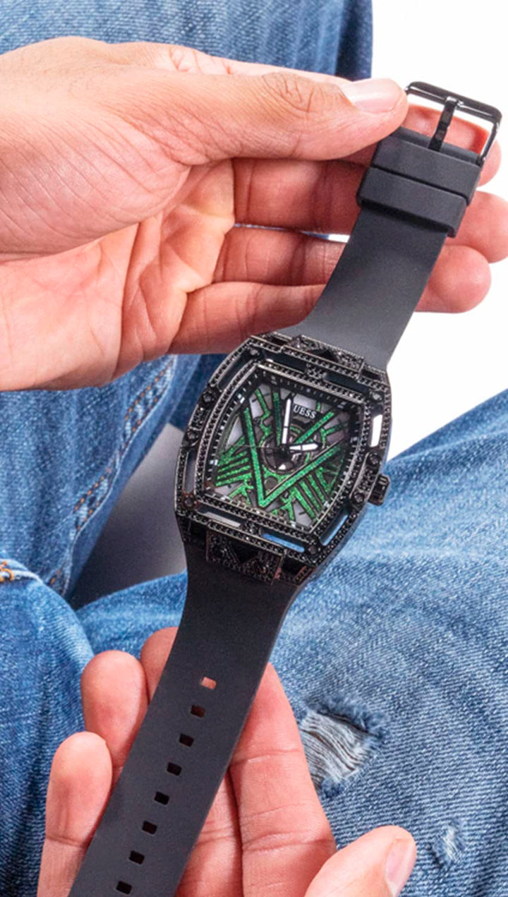 Unisex black watch with crystal-set case, geometric black dial and green accents, silicone strap