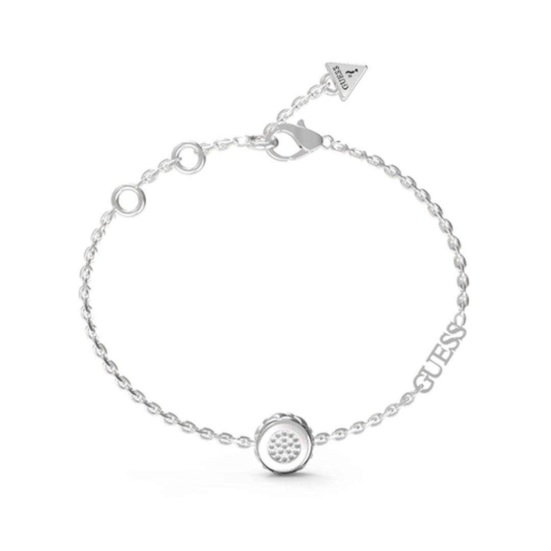 Delicate silver chain bracelet with round stone-embedded charm, lobster clasp and triangle tag on neutral background